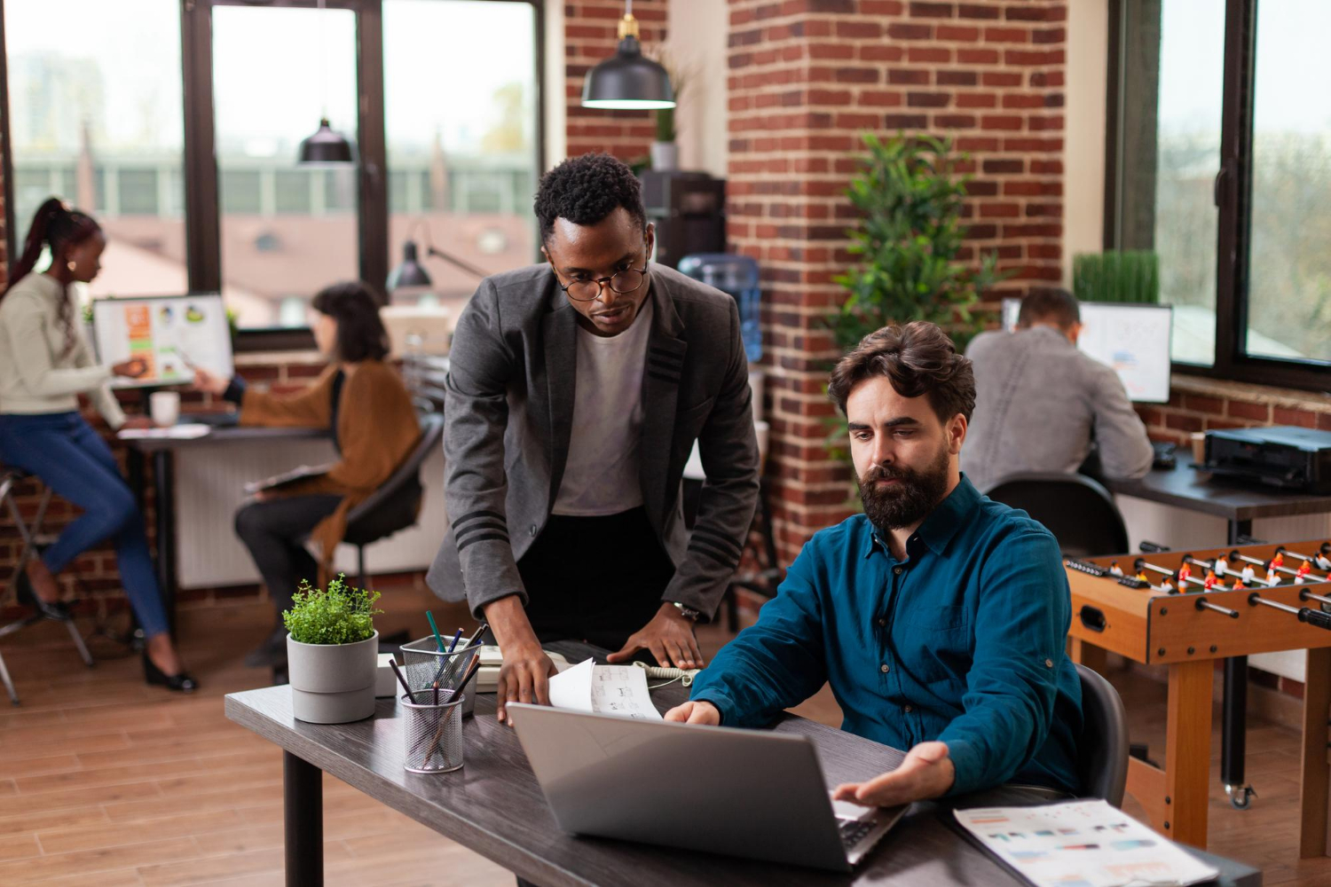Homepage 16 multi ethnic businesspeople brainstorming ideas marketing project while working company strategy brick wall startup office diverse team analyzing statistics planning business collaboration 1
